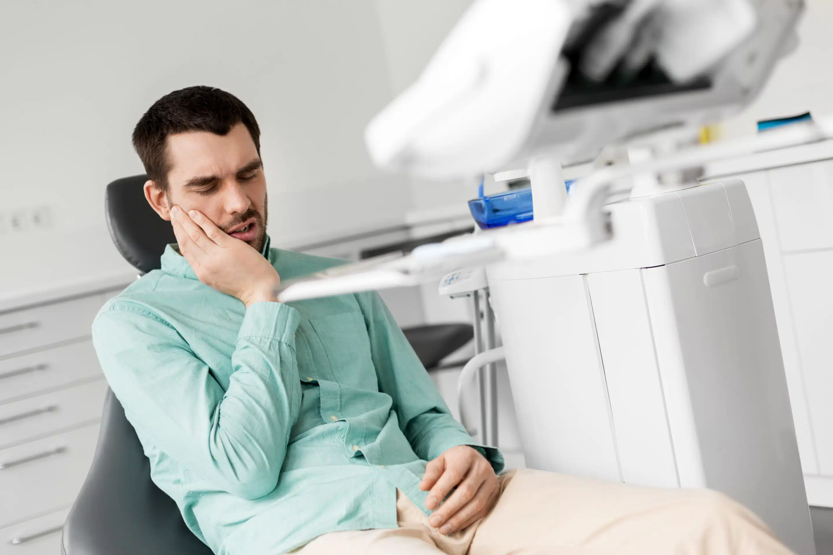 patient having toothache at dental clinic office